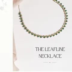 The Leafline Necklace, a statement of timeless elegance. This piece features a delicate line of emeralds, yellow sapphires, and diamonds, perfect for adding a touch of color to any outfit.