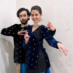 A joyful moment during a duet performance. Dance isn't just serious expressions; it's also about sharing happiness and positive energy with the audience and your fellow performers.