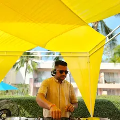 Behind the decks at a vibrant daytime event in Hua Hin, Thailand. The bright yellow decor matched the sunny, happy atmosphere of this destination wedding.