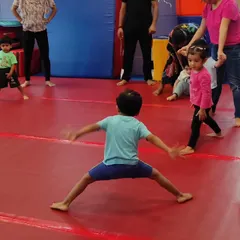 A candid moment of children interacting during class. Our gym is a social space where friendships are formed while practicing physical skills.