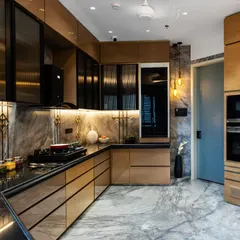 This kitchen design showcases the classic and timeless combination of rich gold, black, and natural wood. We used fluted glass on the upper cabinets and integrated under-cabinet lighting to create a space that is both highly functional and exceptionally stylish.