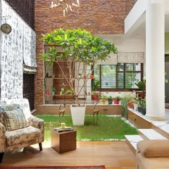 The sunken courtyard is the soul of this home. It acts as a natural air-conditioner and a visual anchor, with the living space planned to allow for constant engagement with this patch of green.
