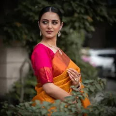 A portrait from a commercial jewelry shoot, where the model's elegant pose and the natural green background highlight the diamond necklace.