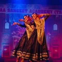 Two of our senior students performing a synchronized Kathak piece on stage. We train our dancers in coordination and stage presence, preparing them for duet and group performances.