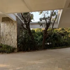 Here, a covered walkway at Vidyamandir School opens up to a view of the lush, landscaped grounds. We intentionally designed these transitional spaces to blur the boundary between inside and outside, ensuring students and faculty are always connected to the natural environment.