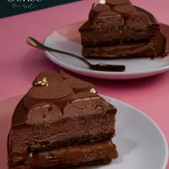 Two slices of the Midnight Sun, showcasing the perfect balance of dark chocolate and rich caramel. It's a moment of indulgence, designed to be shared.