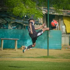 It's all about skill and agility. Here, one of our young athletes executes a perfect aerial kick during a competitive Pride Cup match, showing the high level of technique we teach.
