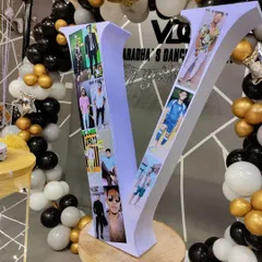 We can create personalized props like this large letter 'V' filled with a collage of photos. It's a wonderful and personal centerpiece for a birthday or anniversary celebration.