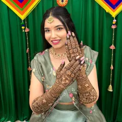 A happy bride glowing in her beautiful henna. This full-arm design incorporates personalized elements that are meaningful to her, showcasing how I tailor every bridal mehndi to the individual.