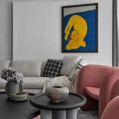 In this home, every wall is a canvas. This shot shows how carefully selected furniture, like the sculptural coffee table and textured vases, complements the bold artwork without competing with it, creating a harmonious and artistic composition.