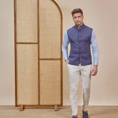 A full-length view of the modern ethnic look, showing the navy Nehru vest paired with off-white trousers for a sophisticated and timeless ensemble.