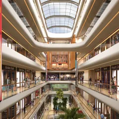 The multi-level atrium of the Town Hall in Siliguri is designed as a vibrant social hub. The grand, curved balconies and expansive glass ceiling create a sense of openness, drawing people into a dynamic retail environment that encourages interaction and community engagement.