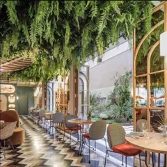 I also create dramatic ceiling installations. For this restaurant, I designed a suspended garden with hanging artificial ferns that covers the entire dining area, giving it a unique, immersive atmosphere.