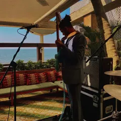 Our guitarist warming up during soundcheck at a beautiful seaside venue. Getting the sound just right is a critical part of our preparation for every show.