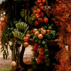 Here, I crafted a cascading arrangement of seasonal fruits and vegetables. Tomatoes, peppers, and bananas hang like natural garlands amidst a backdrop of rich, autumnal foliage, telling a story of harvest and abundance.