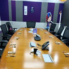 Another corporate event setup, this time for a model-building activity. Each seat at the conference table is set with a wooden vehicle kit, ready for kids to assemble and learn about engineering.