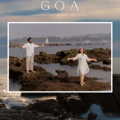 Gurneet and Gurbani embrace the serenity of a Goan beach, with the sea and a distant sailboat creating a picturesque and romantic setting.