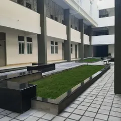 The open courtyard at the St. John's hostel block is designed for relaxation and connection. The clean lines of the planters, the greenery, and the tiled paving create a calm, orderly, and refreshing open space.