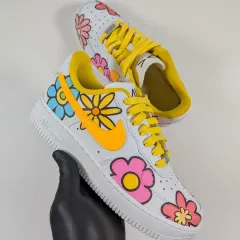 Holding up the completed floral Air Force 1. The design is fun, vibrant, and perfect for anyone who loves flowers.