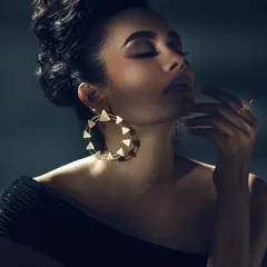 Jewellery photography is all about precision. Here, I used soft, directional lighting to highlight the intricate details of the earrings and ring without creating harsh reflections. The model's pose and expression add a layer of elegance, telling a story beyond just the product.