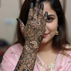 The best part of my job is seeing a client's happiness. Here's a beautiful bride showing off her full-arm floral henna, a design that took hours of 'mehnat' but was worth every second for this smile.