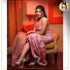 A seated portrait that exudes confidence and glamour. The lighting catches the beautiful shimmer on her skin and the elegant details of the makeup, perfect for an evening event.