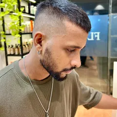 Skin fade on fleek. This popular style features a very close cut on the sides that gradually blends into the longer hair on top.