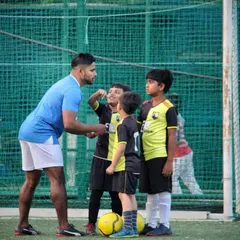 A moment of encouragement between a coach and our young footballers. We focus on guiding our players towards success, celebrating small wins and building their self-esteem on and off the pitch.