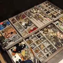 A drawer filled with beautifully organized jewelry. Using grid-style velvet trays protects each piece and allows you to see your entire collection of earrings and rings at once.