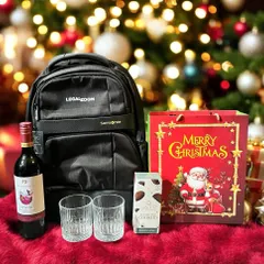 A Christmas-themed corporate gift for the employees at LegalZoom. This festive set includes a Samsonite backpack, a bottle of wine, whiskey glasses, and cookies.