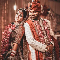 A classic back-to-back pose with a twist. The bride looks confidently at the camera while the groom looks lovingly at her, capturing their individual personalities and their connection as a couple.