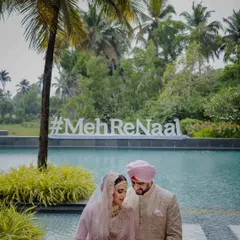 Together is a wonderful place to be, especially in Goa. The couple poses by the pool with their custom wedding hashtag, a perfect blend of modern style and the lush, tropical beauty of their destination wedding venue.