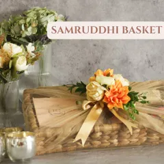 Our Samruddhi Basket is a rectangular handcrafted basket that is both rustic and chic. We wrap it in delicate netting and adorn it with flowers for a beautiful finish.