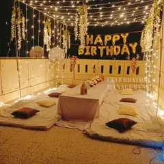 This cozy terrace setup is perfect for a relaxed birthday gathering. I created a canopy of lights with hanging white wisteria and set up mattresses and cushions for comfortable floor seating.