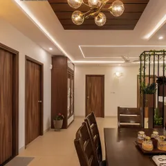 A view of a dining area adjacent to the kitchen, featuring a dark wood dining table and a stunning pendant light. The design shows how I create a cohesive flow between cooking and dining spaces.