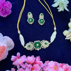 A unique and modern choker design. This piece features a hexagonal emerald-colored stone set in a delicate frame of American Diamonds, perfect for a chic, contemporary look.