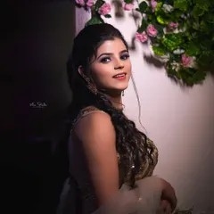 A beautiful bridal portrait using dramatic lighting. The way the light falls on her creates a soft yet striking image that highlights her features and elegant attire.