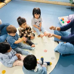 Circle time for our toddlers often includes number rhymes and counting games, introducing numeracy concepts in a playful, social setting.