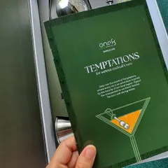 A close-up of the branded insert for the One8 "Temptations" cocktail kit. We design and include custom print materials like menus and thank you cards to communicate your brand's message effectively.