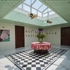 At the heart of The Blooming Garden, the central atrium gathers light, breath, and memory. We designed this inward-looking courtyard with a large skylight and mint-green lattice panels to connect the home's past to its present, creating a space for daily rituals to unfold.