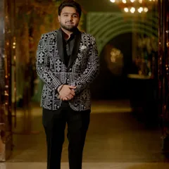 A happy client looking sharp in a black and white patterned tuxedo. This is a perfect look for a reception or party, combining classic colors with a modern print.
