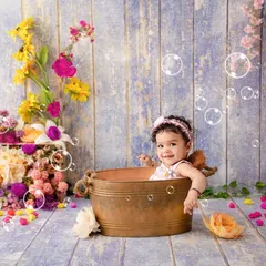 Who loves bubbles? Nine-month-old Mahira certainly does, enjoying her floral-themed bath time shoot.