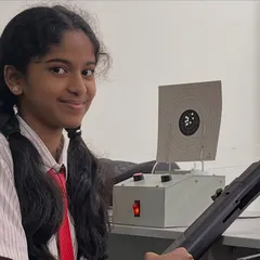 A student from BS International School smiles after a great practice shot. We have partnered with the school to set up a shooting range in the Electronic City area, making the sport more accessible.