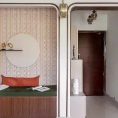 An existing niche in the living room was transformed into this cozy reading alcove with a built-in bench and storage. The patterned wallpaper and arched frame add a playful yet elegant touch.