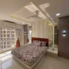 Natural light floods this bedroom, highlighting the clean lines and elegant finishes. The design maximizes both comfort and style.