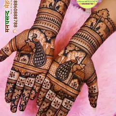 A beautiful example of traditional Indian mehndi, showcasing majestic peacocks on the palms. The dark, rich stain highlights the fine lines and detailed patterns that extend up the forearms.