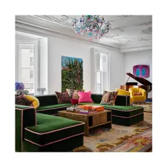 Whimsy meets indulgence in this iconic apartment. The pairing of green velvet with bright pink and yellow, along with a multi-coloured carpet, shows how to work with contrasting colours to create a joyful, vibrant space.