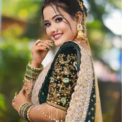 A glamorous party look featuring smoky eyes and a glossy lip. This model is wearing a beautiful dark green and gold outfit, perfect for a festive occasion.