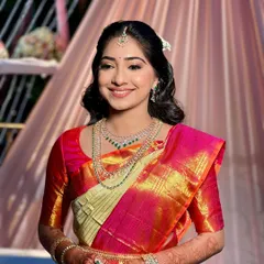 The complete South Indian bridal look. The simple, elegant hairstyle and fresh makeup allow the stunning Kanjivaram saree and traditional temple jewelry to take center stage.