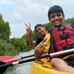 The joy of mastering a new skill is clear on this young camper's face during a kayaking session at our Malpe camp. We provide all the gear and guidance needed for a safe and fun introduction to paddling.
